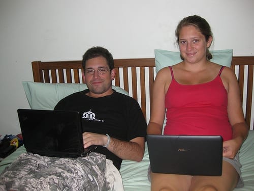 Mike and I Working in Bed - Should You Start a Travel Blog: The Dirty Truth
