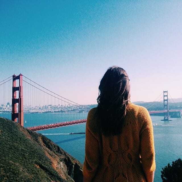 A Girl Standing in Front of the Golden Gate Bridge - How to Travel and Work Full Time