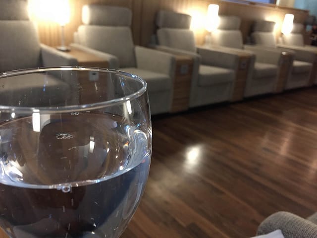 A Glass of Sparkling Water in the IcelandAir Lounge - What Travel During First Trimester is Like