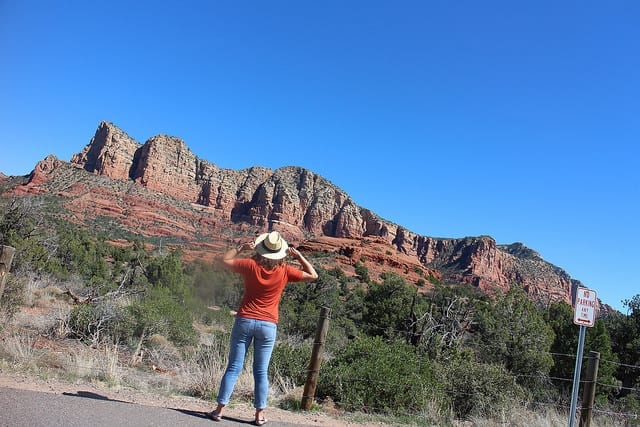 The Back of a Woman Looking Up at the Red Rocks - Pooping Your Pants on the Road