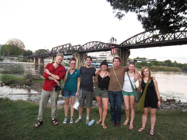 A Group Tour in Front of a Bridge - How to Meet People While Traveling as a Couple