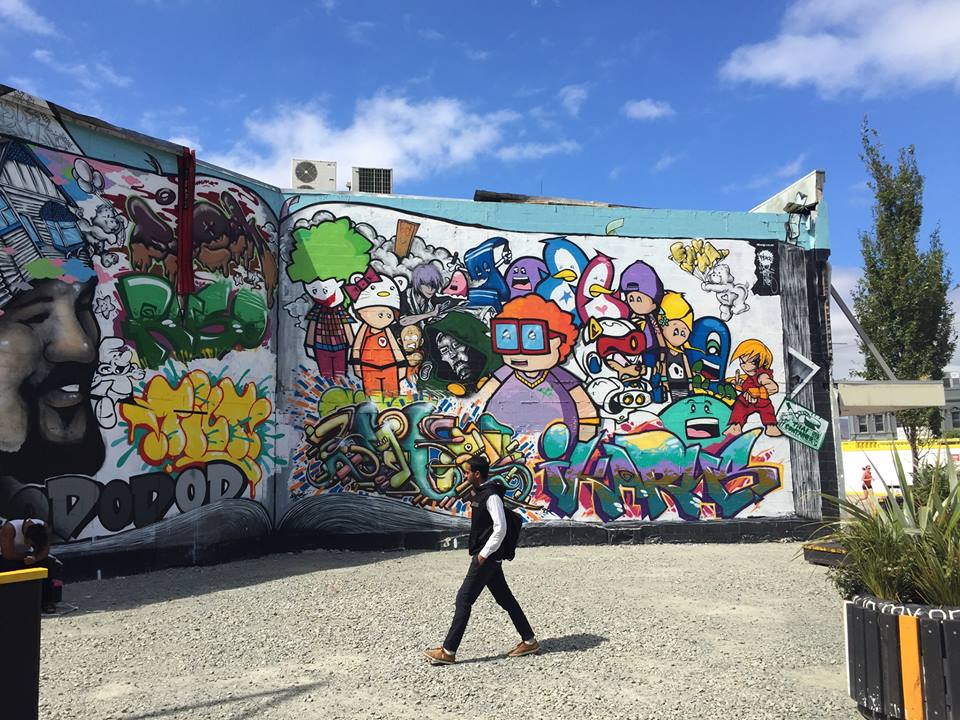 Graffiti on the walls of Christchurch, New Zealand as a pedestrian walks by